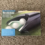 Nip / Sealed Brookstone Automatic Putting Cup Cordless Portable. Fixed Price $14.99.
